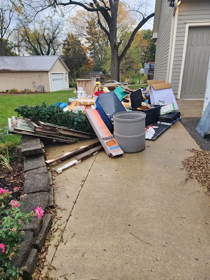 Dumpster being loaded with debris for Commercial Dumpster Rental in Clifton